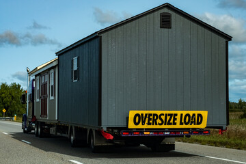 Sheds as oversize load on semi transport truck