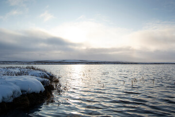 autumn landscape with a lake and snow in the tundra