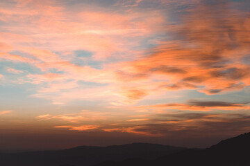 Fototapeta na wymiar Sunset between mountains with clouds and colorful sky