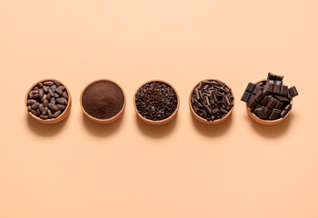 Cocoa and chocolate ingredients in bowls. Cacao beans and chocolate assortment top view