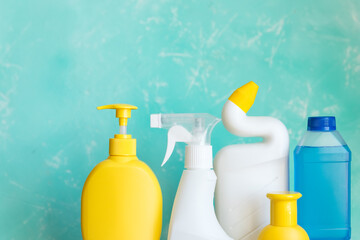 Professional cleaning equipment on blue background overview. Cleaning tools concept. composition with Plastic detergent bottles. House cleaning products.Detergents, chemical bottles, cleaning sponges