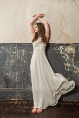 Beautiful woman wearing white dress in vintage interior