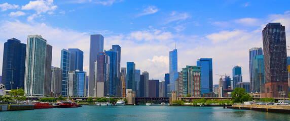 View of Chicago Skyline from Lake Michigan on a partly cloudy blue sky day.