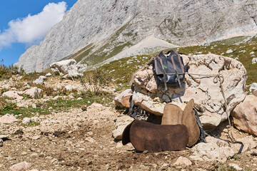 saddler's temporary workplace outdoor in the mountains while grazing livestock in highlang pastures...