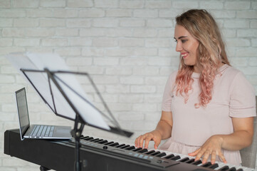 Remote music lessons. A singing teacher records the lesson on a laptop webcam.