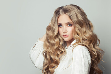Pretty blonde woman with long healthy curly hair
