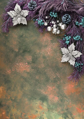 Abstract Christmas background with purple pine branches, berries and decorations on an orange-green background. Holiday background, top view. The concept of the new year 2021 and Christmas.