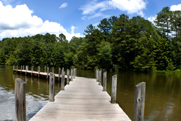 Wooden fishing pier jetting out over lake