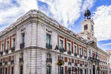 View of House of the Post Office (Real Casa de Correos) with Clock Tower - an eighteenth century (1768) building in Puerta del Sol, Madrid. Spain. - obrazy, fototapety, plakaty