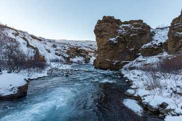 Cliff above glacial river in Glymur, Iceland
