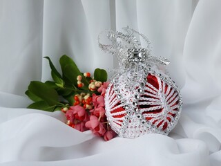 Unique handmade  crocheted Christmas tree decoration on white background. Christmas globe.
