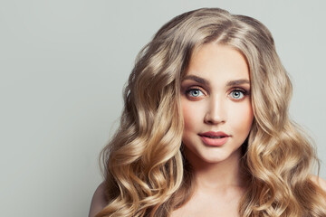 Fototapeta premium Portrait of attractive woman with long healthy curly blonde hairstyle