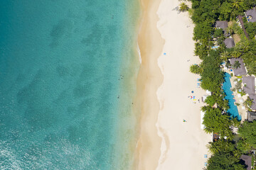 View from above, stunning aerial view of a beautiful white beach bathed by a turquoise, clear...