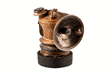 Vintage miner's lamp isolated on white.