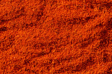 Pile dried crushed hot red pepper, paprika texture background