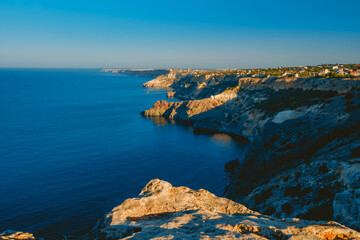 Summer seascape with Fiolent rocks formation on the coast of Sevastopol. view on cape in the sea, clear azure water, calm hot day. 