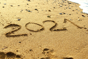 Happy new year 2021 text on the sea beach. Abstract background photo of the upcoming new year 2021