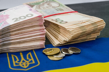 bundles of hryvnia and the flag of Ukraine. Ukrainian money. 200 and 500 hryvnia banknotes. A lot of Ukrainian money. Hryvnia stacks