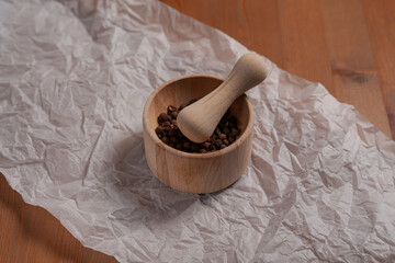 Wooden mortar for spices on the table