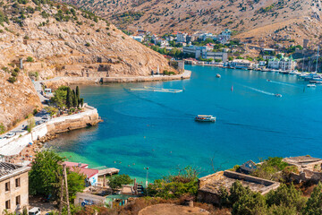 Obraz premium Picturesque panoramic view of Balaklava bay with yachts and green hills. Sevastopol, Crimea.