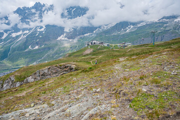 Fototapeta premium Ski resort lift station surrounded with green pastures during the summer.