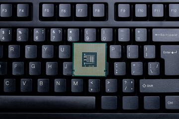 cpu central processing unit close up on a desktop keyboard background. computer hardware industry conceptual