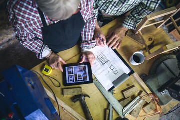 Top view of unrecognizable senior couple working in a carpentry workshop