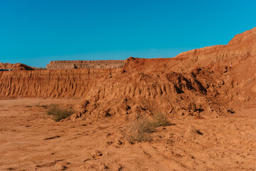 Rocky formations and mountains in sandy desert