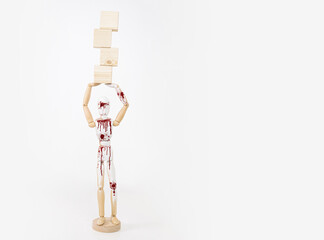 Mannequin with wooden cubes. Content completion concept. A mannequin on a white isolated background is holding wooden empty cubes.