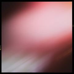 Blurred abstract colored pink and gray, black background in a black frame along the contour, slide film.