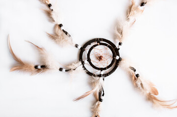 Dream catcher on a white background. Feather toy. Feather ring. Dreamcatcher amulet