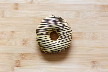 Top view of donut on the background of wooden table.