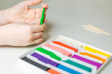 
the child sculpts plasticine