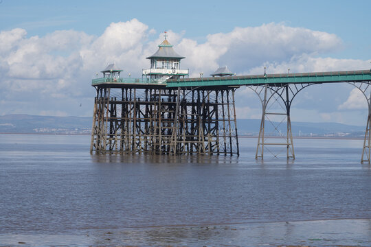 Panoramic photo of Clevedon Pier in somerset showing iron structure against blue sky