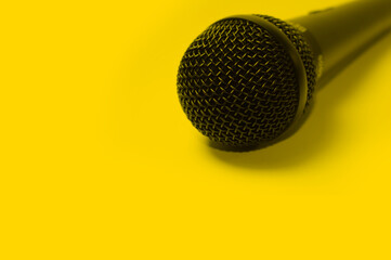 Microfone preto com fundo amarelo