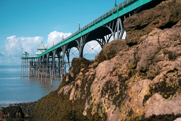 Obraz premium Panoramic photo of Clevedon Pier in somerset showing iron structure against blue sky