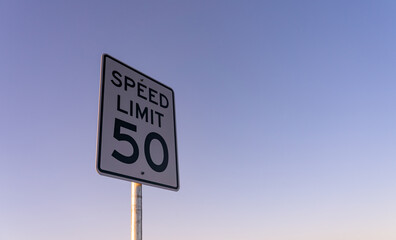 View of Speed Limit Sign on the Side of Road During Early Morning