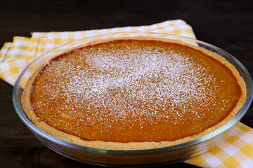 Fresh Baked Tasty Homemade Pumpkin Pie on the Kitchen Table