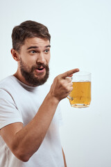 man with a mug of beer in his hands and a white t-shirt light background mustache beard emotions model