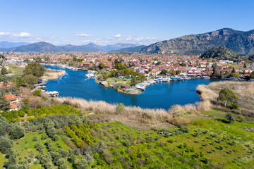 Fototapeta na wymiar Dalyan canal view and settlement, excursion bout tour on Dalyan river valley. Dalyan is popular tourist destination in Turkey. Aerial view from drone.