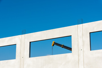 A crane behind a window of the modular building