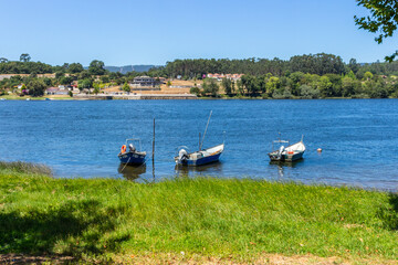 Vila Nova de Cerveira / Portugal - August 1, 2020: Small fishing boats moored in the Minho River.