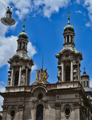 Fototapeta na wymiar Church Towers Against Blue Cloudy Sky in Argentina