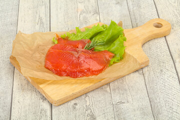 Sliced salmon fillet served rosemary