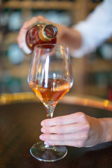 waiter pouring red wine to a woman
