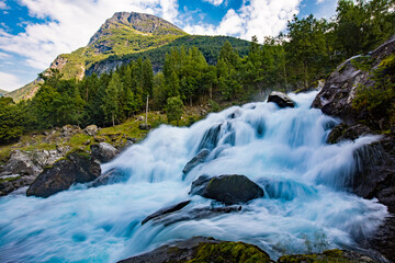 View of the river Geirangerelvi and the waterfall Storfossen in Geiranger, Norway.