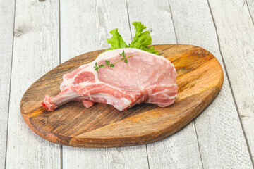 Raw pork bone steak over wooden