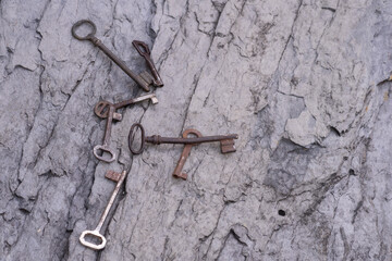 High angle shot of old rusty keys on a wooden surface