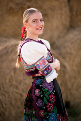 Young beautiful slovak woman in traditional costume. Slovak folklore.