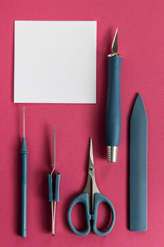 Papercraft tools on pink background
